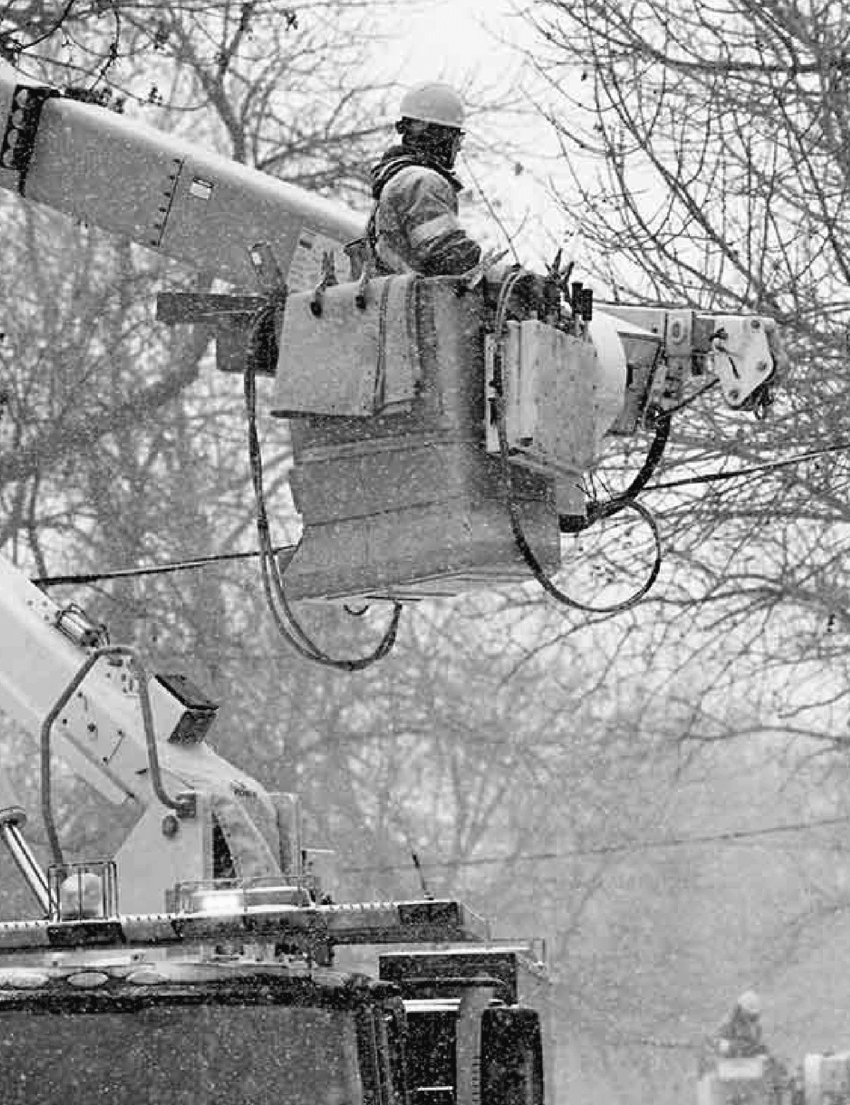 Black and white action shot of person working with heavy machinery